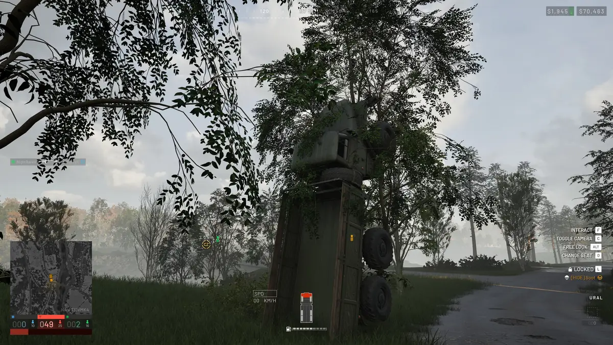 A Ural truck standing vertically in a tree